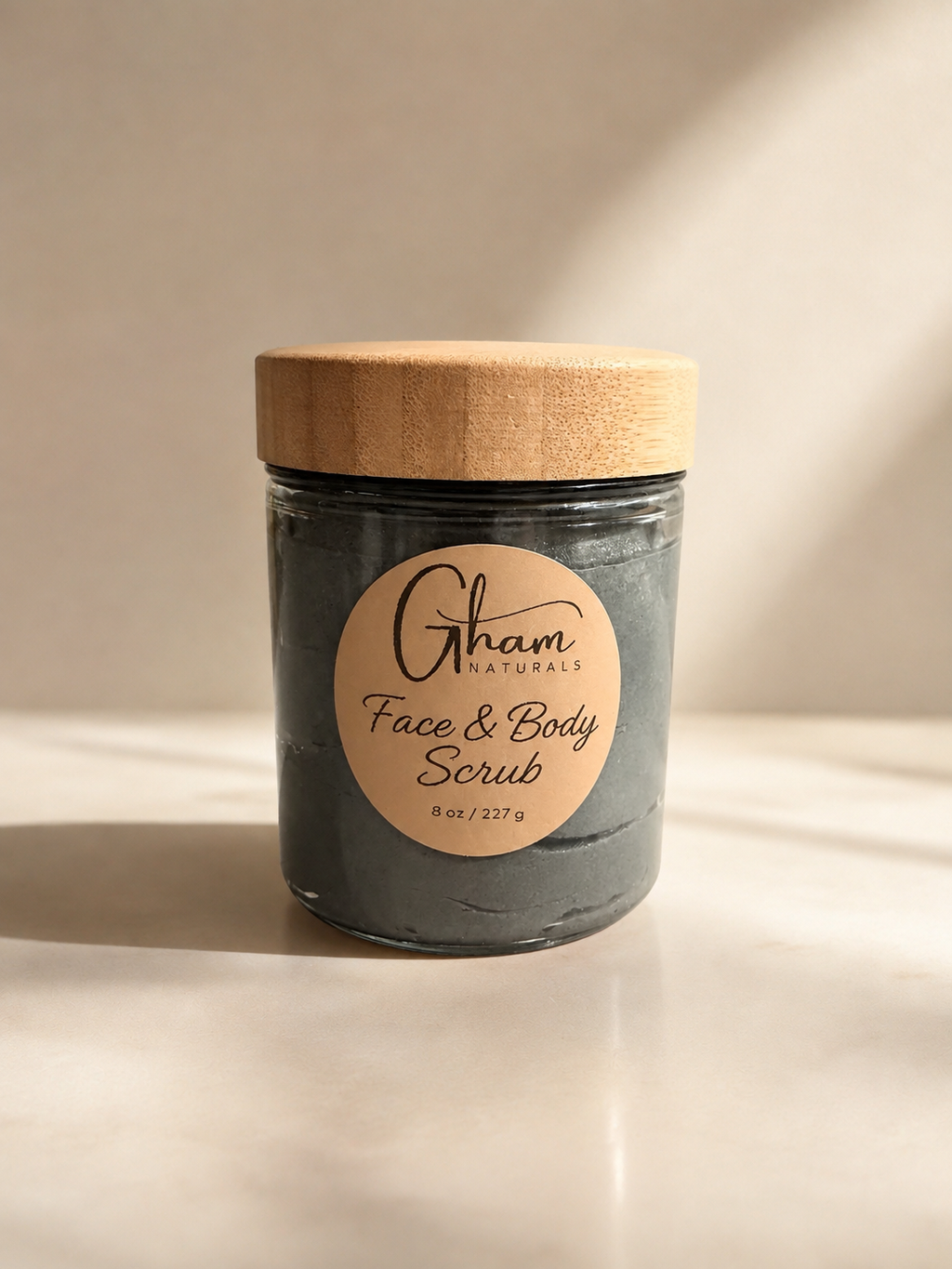 Charcoal & Tamanu Face + Body Scrub in an 8 oz glass jar